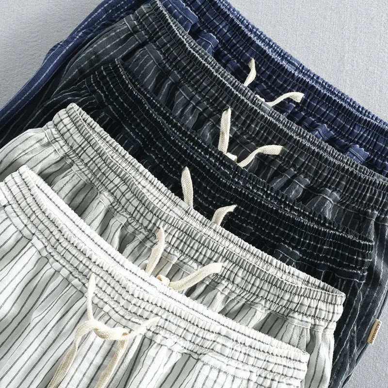 Men's striped cotton casual shorts in a loose straight fit on a mid-waist, shown in light blue colour.