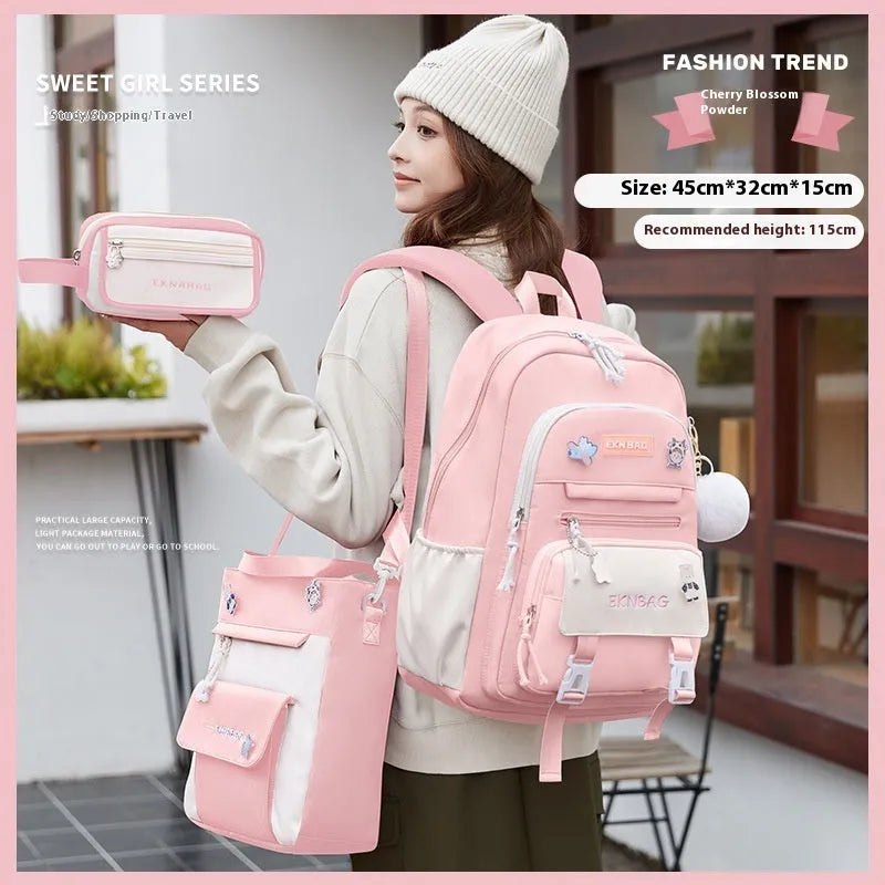Pink waterproof Oxford cloth school backpack for girls with curved shoulder straps on a white background.