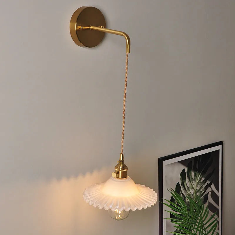 Retro brass lotus wall lamp with a glass shade in a choice of six colours.