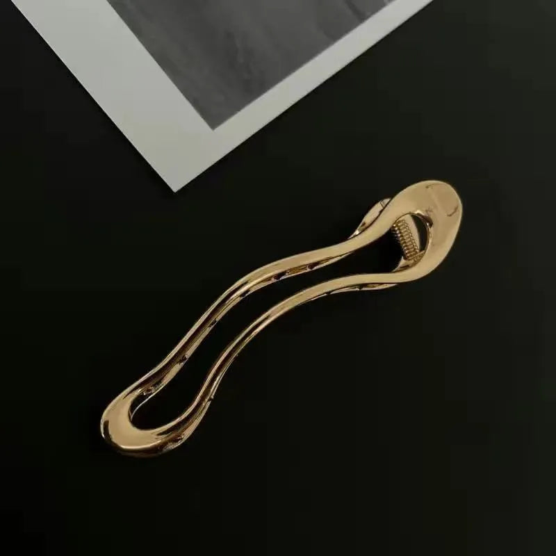 Gold and silver zinc alloy barrettes in square, arc, and triangle shapes for women