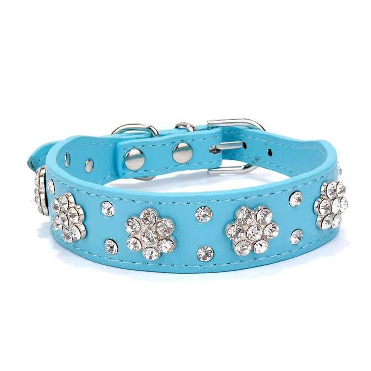 PU leather dog collar with rhinestone flower studs in black, showing metal D-ring and adjustable eyelets.