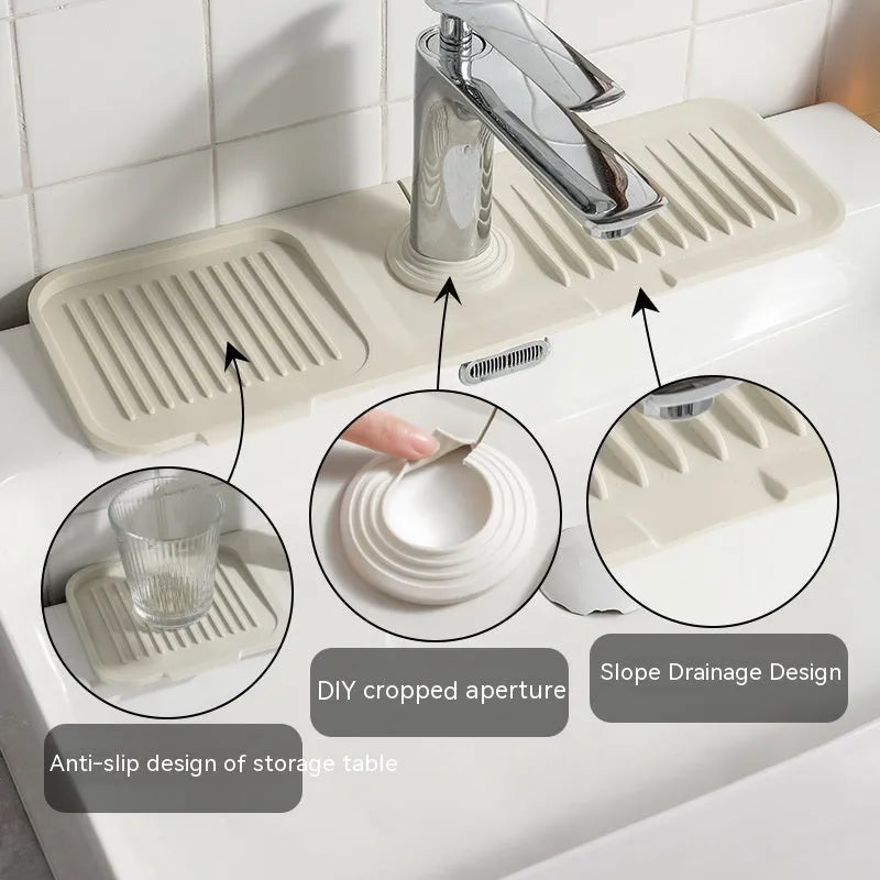 Silicone faucet splash guard pad in sloped design with drain channels on kitchen sink
