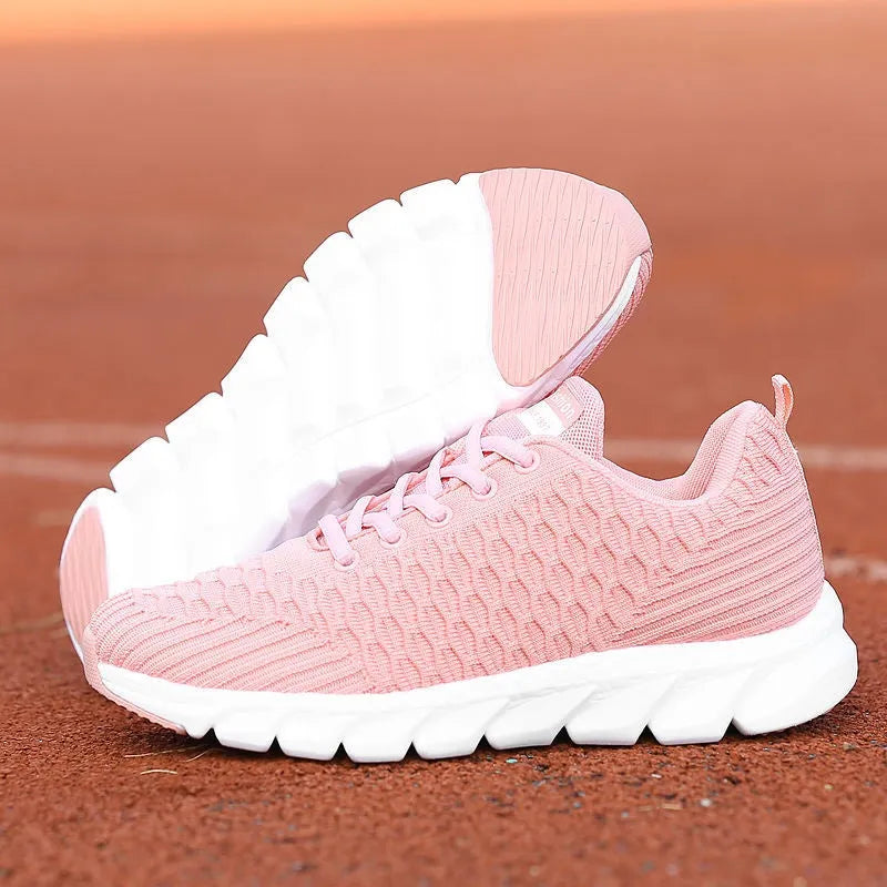 Women's running shoes with fly weave upper in Black, Pink, or White colours showing wear-resistant outsole