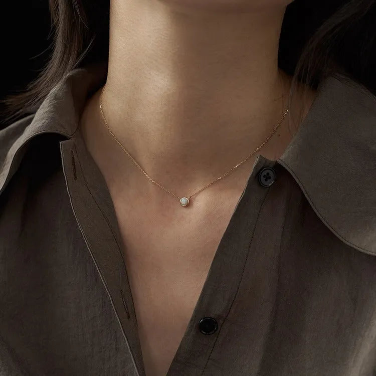 Oval jelly opal pendant necklace on a silver chain with choice of gold or white gold finish.