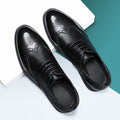 Men's black brogue leather shoes in a business style on a white background.