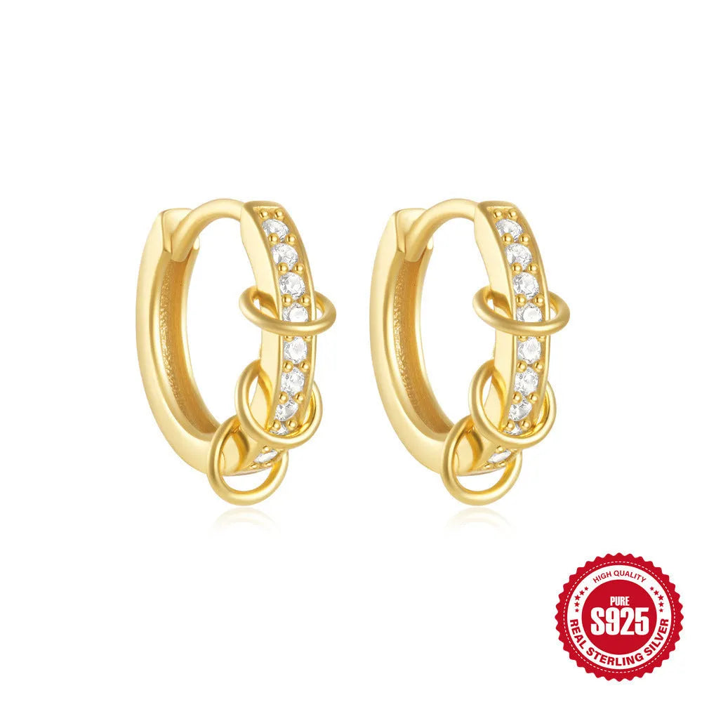 A pair of small, round, geometric stud earrings made of sterling silver with an electroplated finish.
