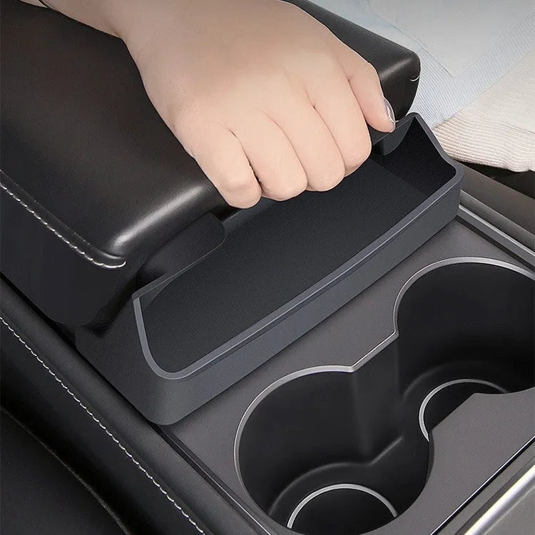 Black silicone glasses storage case installed in a Tesla Model 3 or Y centre console armrest.