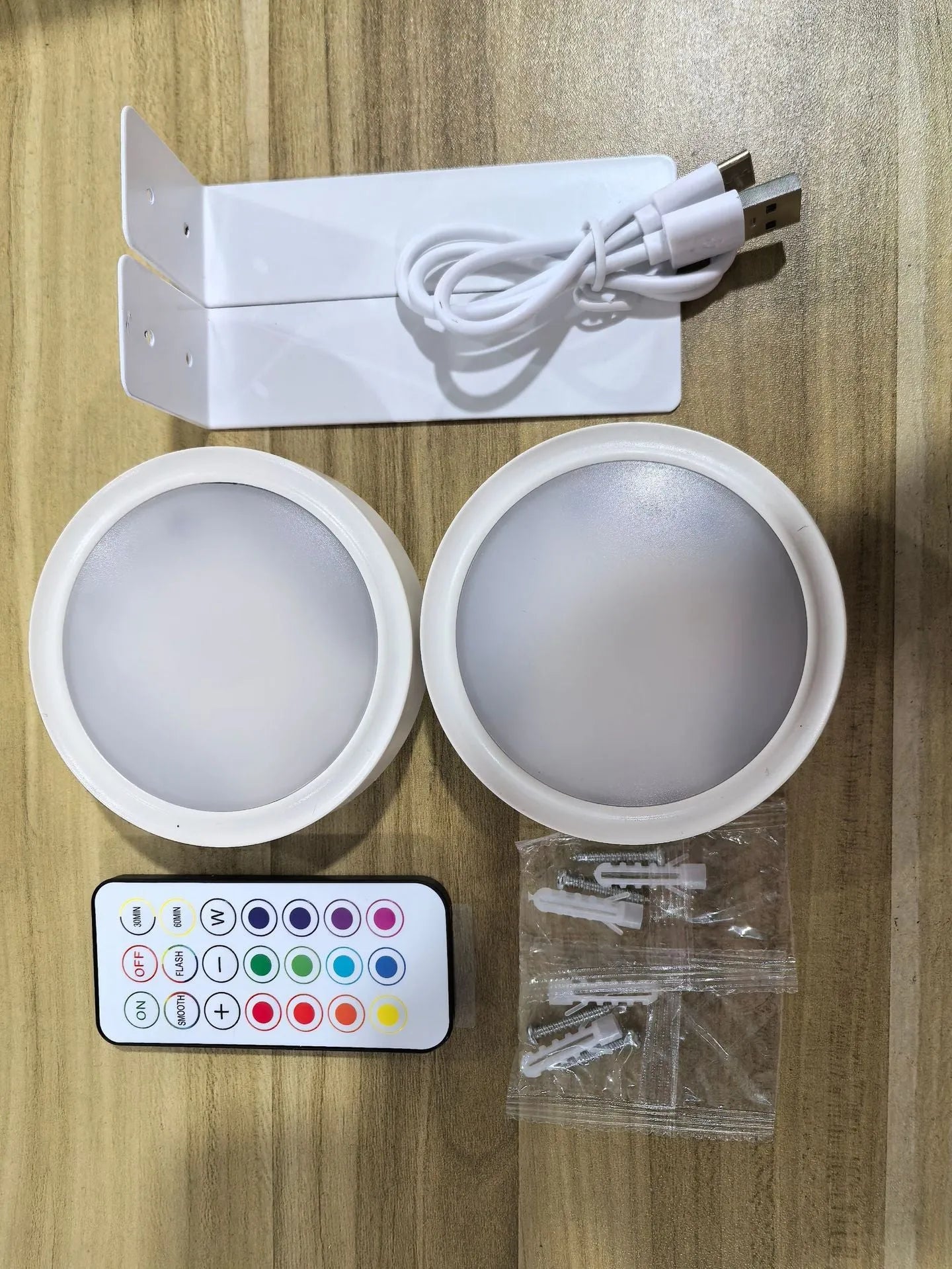 Wireless rechargeable LED painting lamp with magnetic belt attached to a metal frame, remote control nearby.
