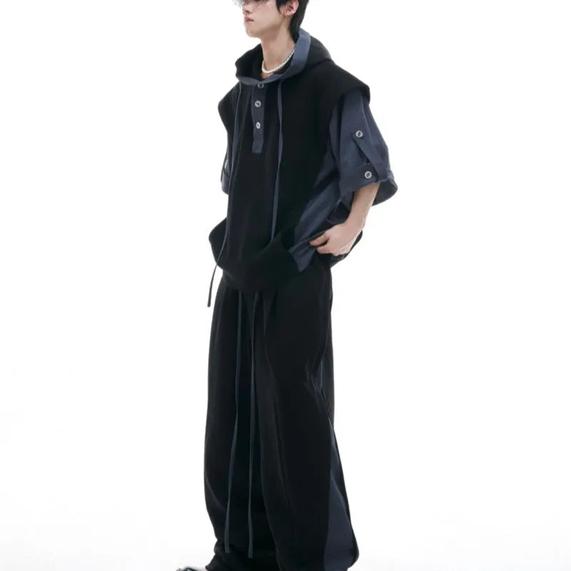 Men's black polyester sports suit with hooded short sleeve jacket and matching trousers laid flat