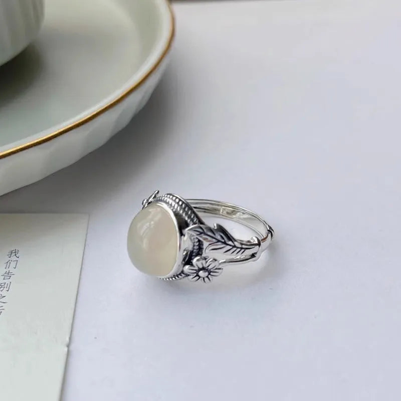 Adjustable copper vintage ring with white chalcedony stone and U-shaped band.