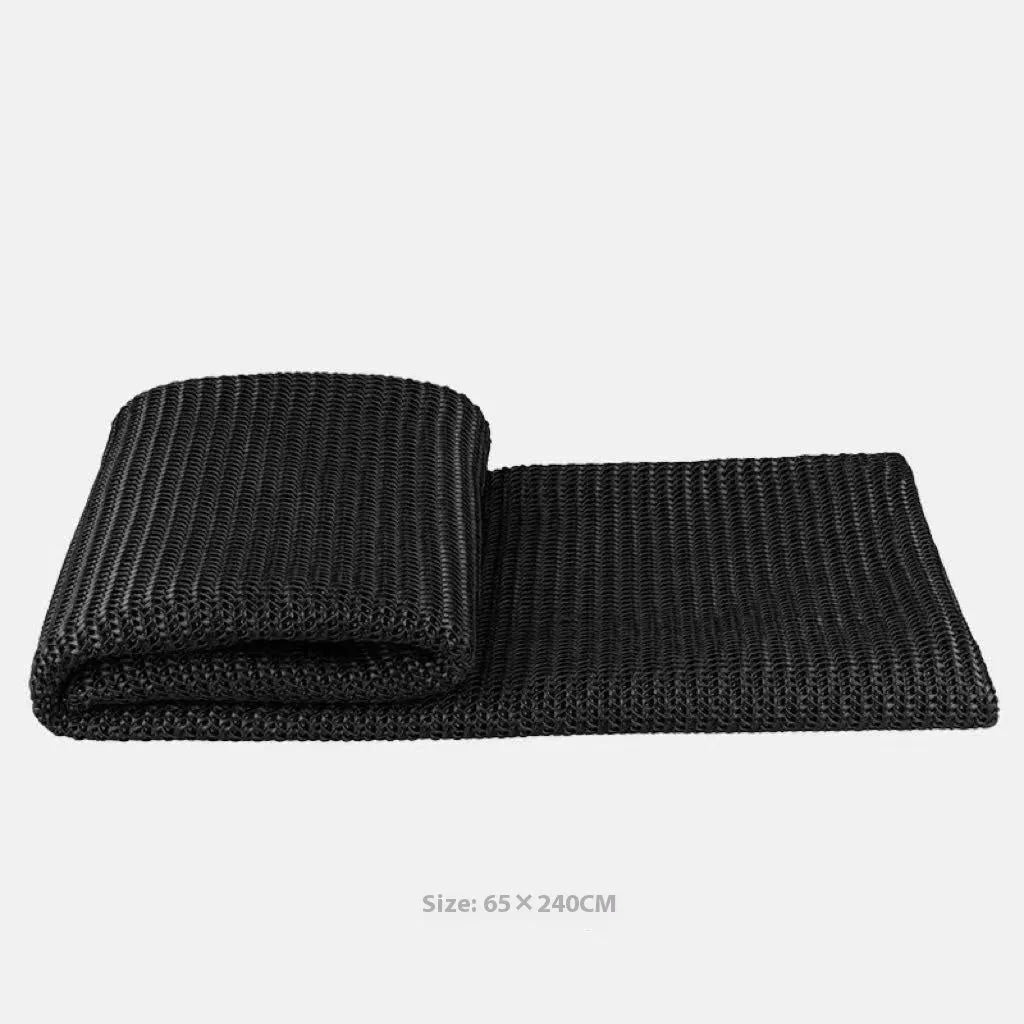 Modern minimalist plaid bed runner set with blanket, pillowcase, and round leather pillow on a bed