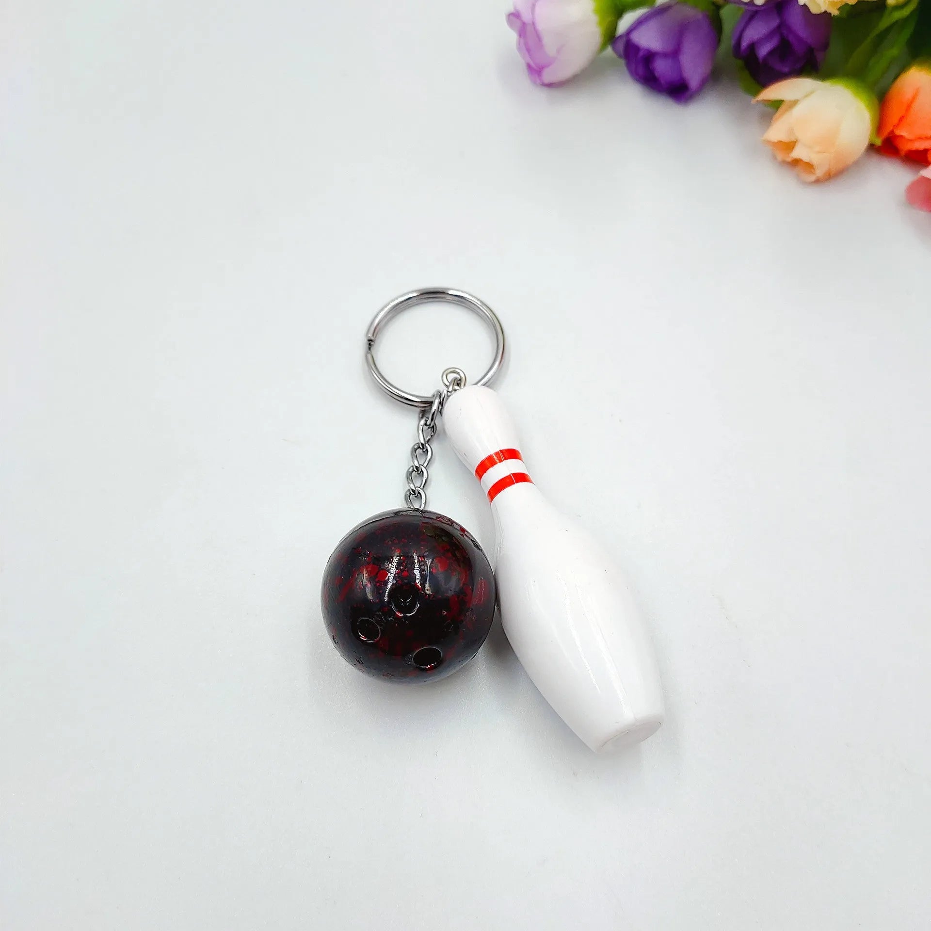 Mini simulation sports bowling pin keychain pendant in blue, dark red, green, or purple colour options.