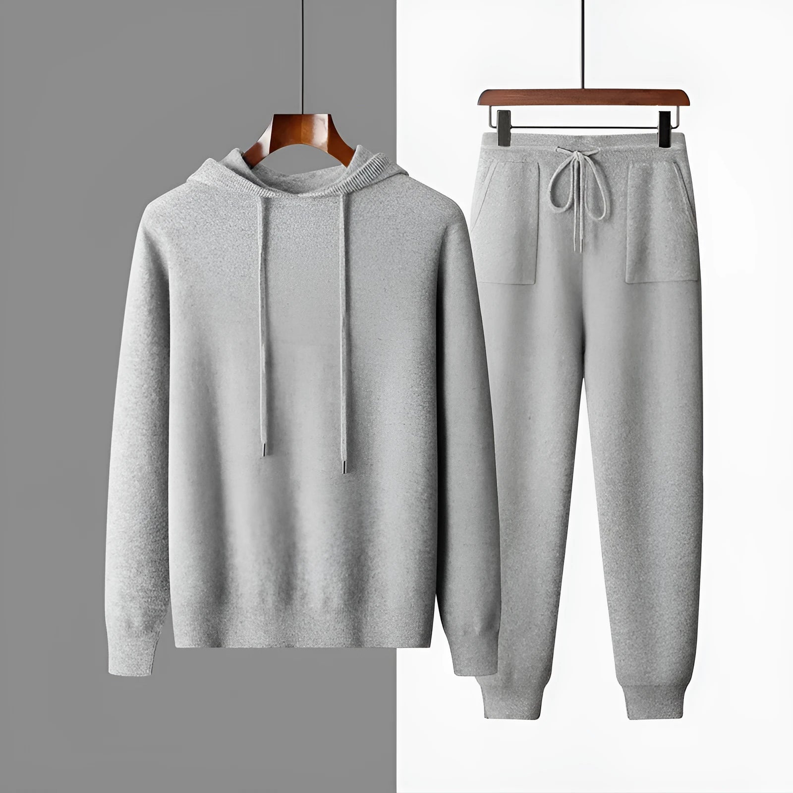 Men's light gray hooded cashmere sweatshirt and matching trousers laid flat as a set.