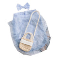 Small dog wearing quiet country shoulder bag carrier in blue, with bow and crossbody bag