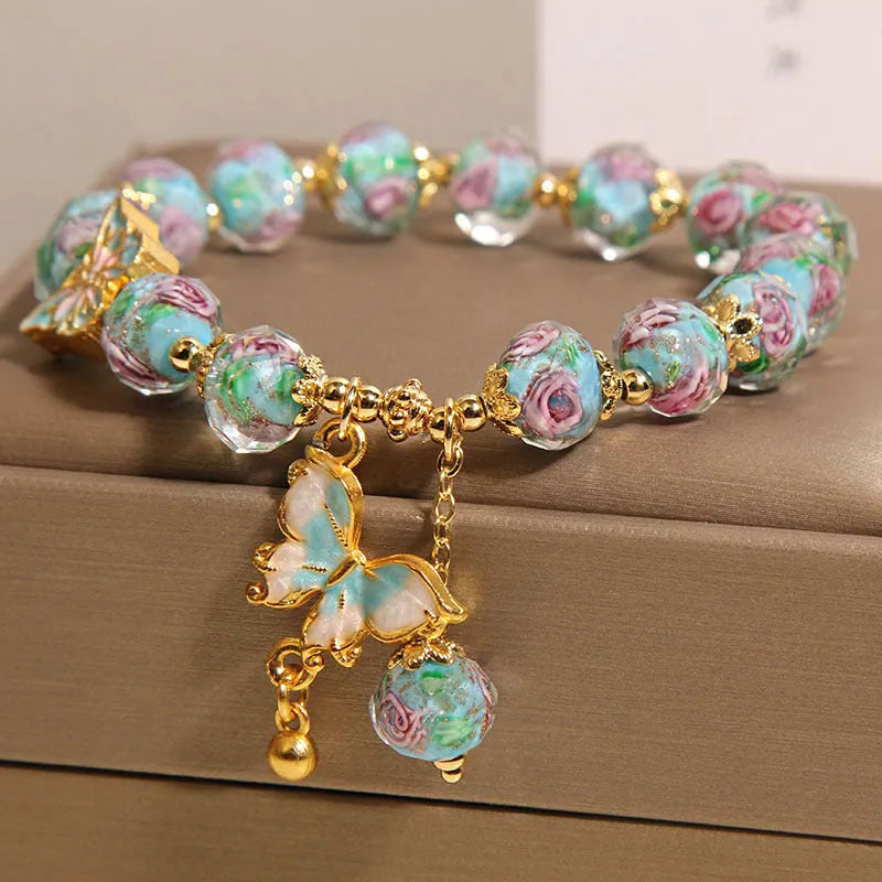 Women's rose garden bracelet with coloured glaze butterfly charm in blue, Japanese Korean style