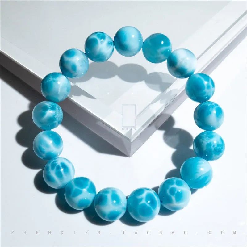Blue and natural toned handmade bodhi bracelet with sea-pattern stones and pearl elements