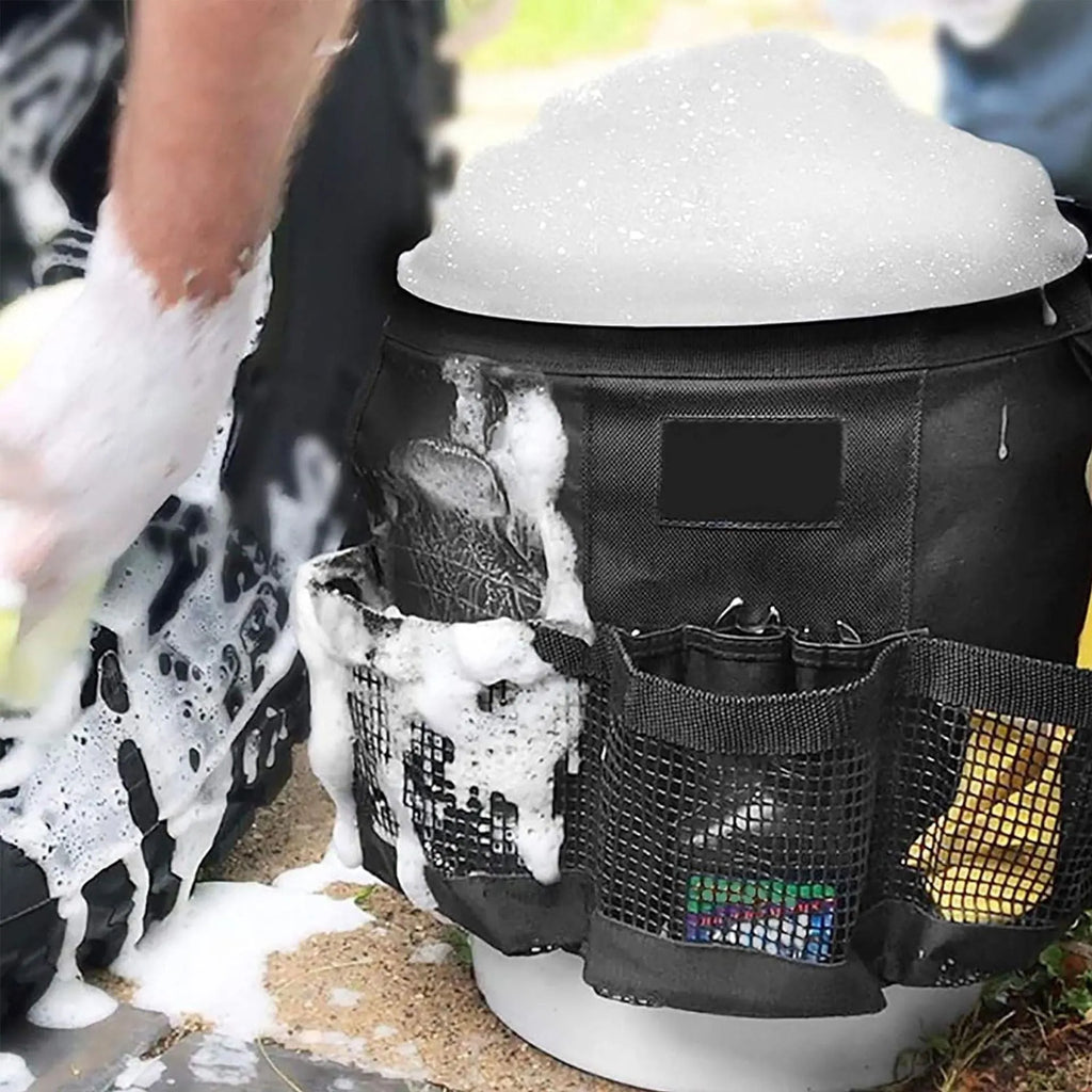 Black cylindrical polyester storage bag hanging on a 5 gallon barrel for tools and toiletries.
