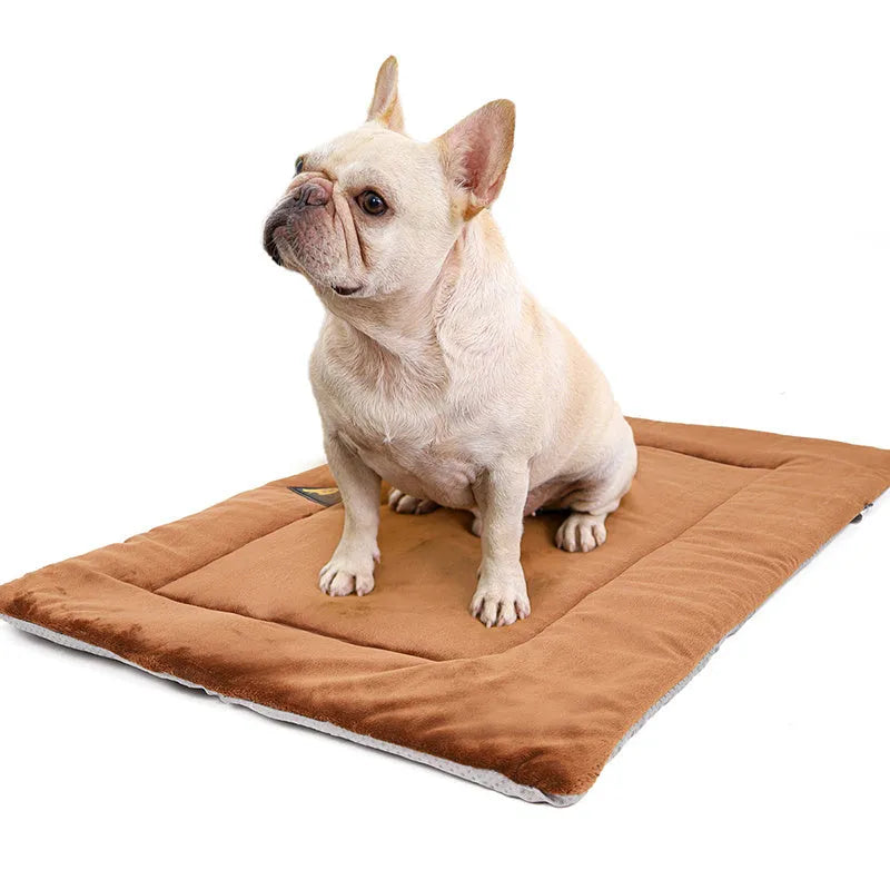Self-heating pet mat in brown with soft fleece surface and non-slip base on wooden floor