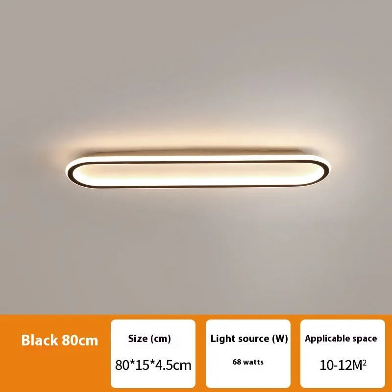 Black aluminium strip ceiling lamp with PVC shade in 60cm length mounted on a white ceiling.