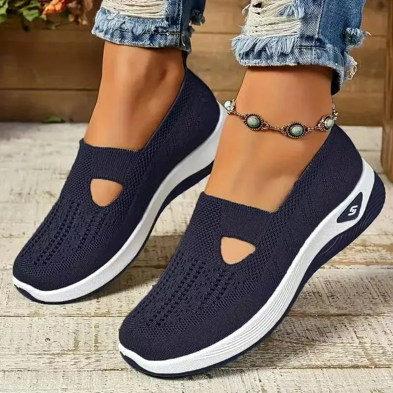 Women's black casual mesh shoes with T-strap and flat soft sole.