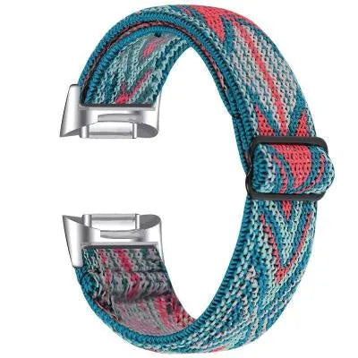 Printed elastic watch strap for Fitbit Charge 6 showing rainbow and arrow print options
