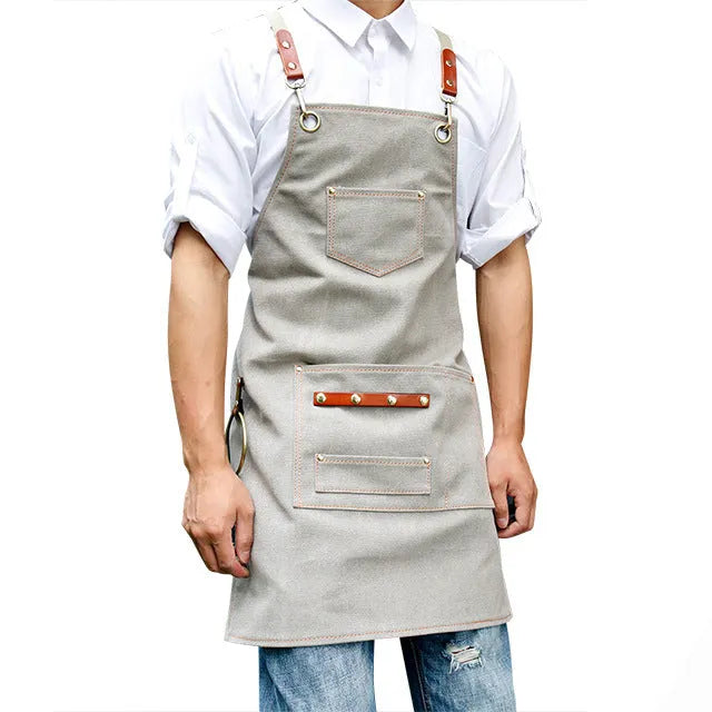 Canvas cross strap apron in camel colour shown from the front.