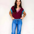 Burgundy contrast trim V neck loose sweater with cuffed short sleeves on mannequin