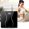 Black electronic digital bathroom scale on a bathroom floor, showing a maximum weight capacity of 180kg.