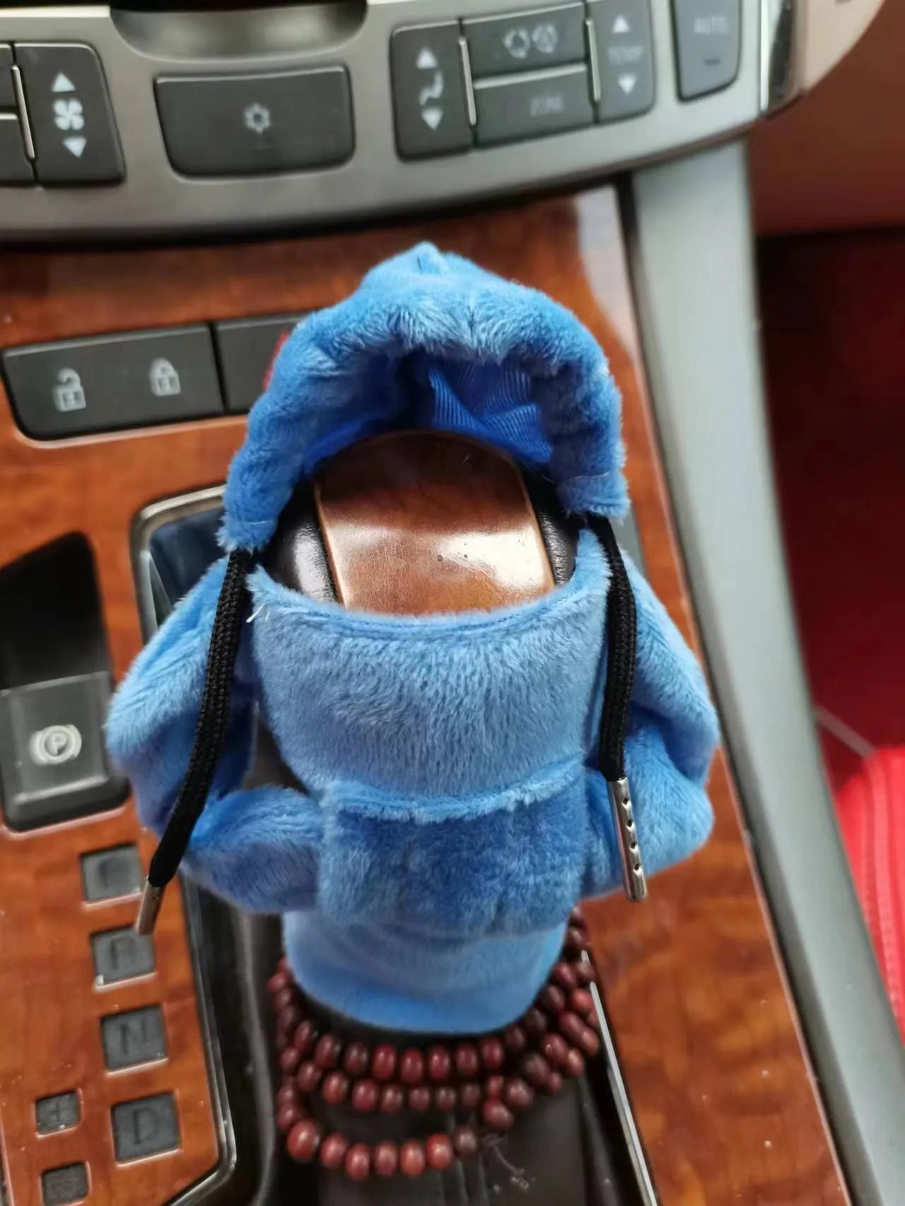 Dutch velvet car gear handle sleeve cover in multiple colours on a car gear lever.