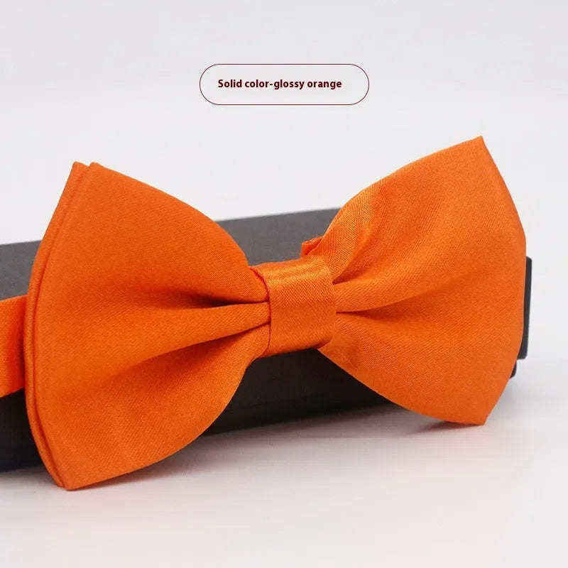 Men's flat head style polyester bow tie in a solid colour, shown with adjustable neck strap.