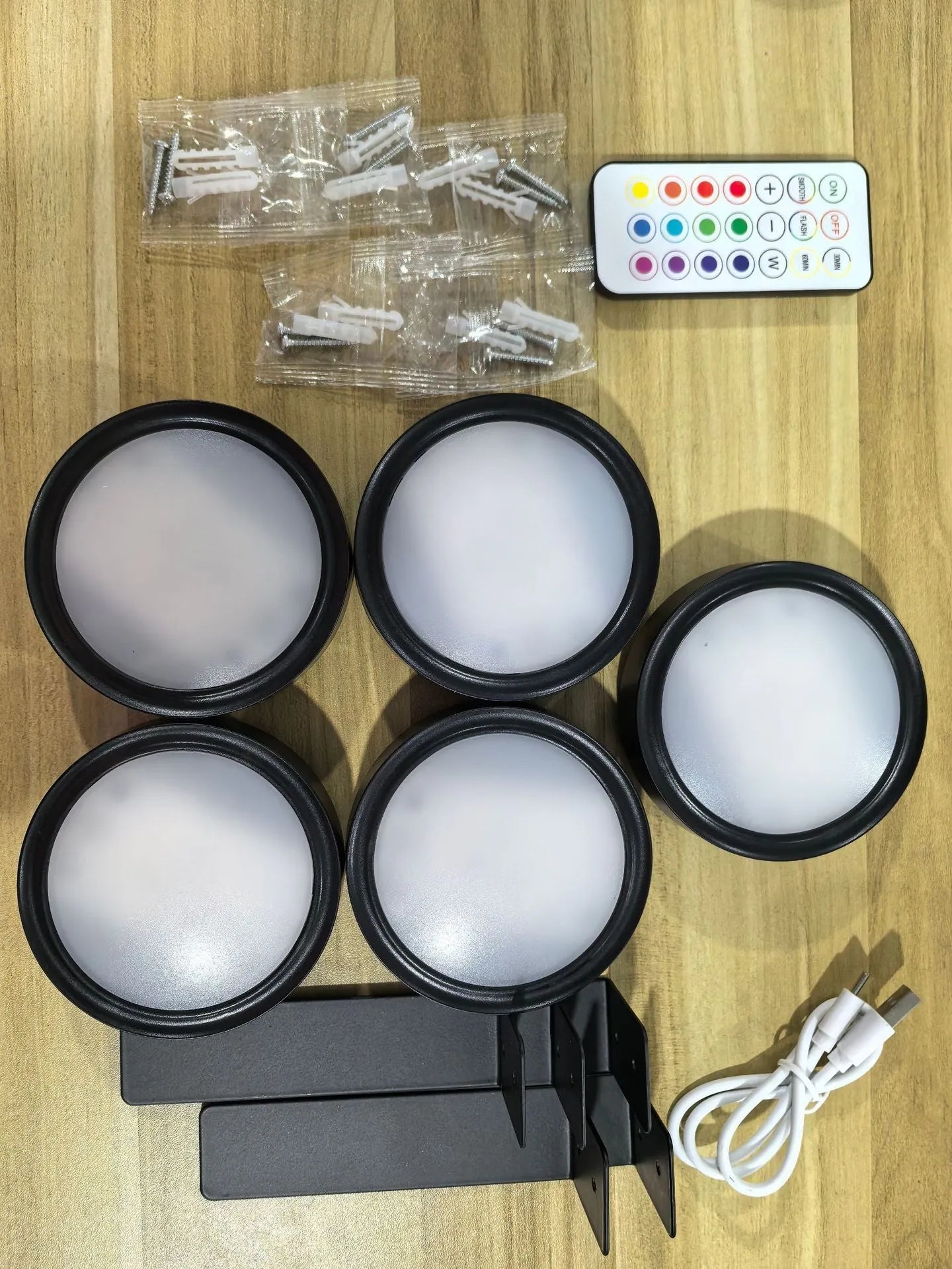 Wireless rechargeable LED painting lamp with magnetic belt attached to a metal frame, remote control nearby.