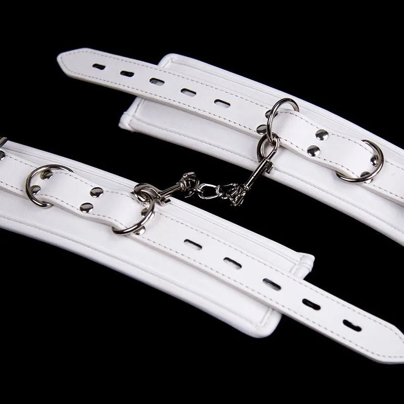 White PU sponge bondage restraint set showing handcuffs, footcuffs and neck scarf