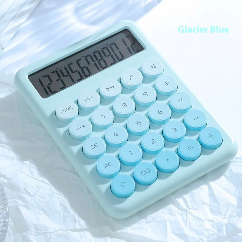 Desktop calculator with a gradient colour design in violet, blue, green, and pink tones on a white desk.