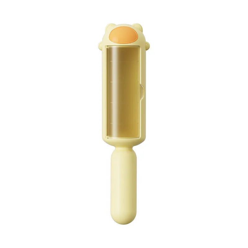 Blue pet hair remover roller with self-cleaning base on a fabric sofa.