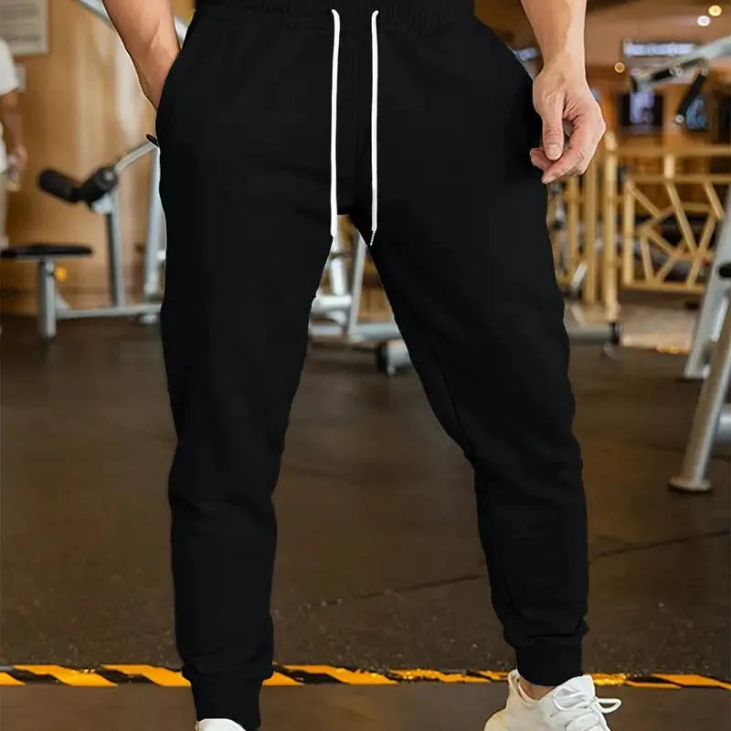 Man wearing grey lightweight linen-style casual trousers with an elastic drawstring waistband.