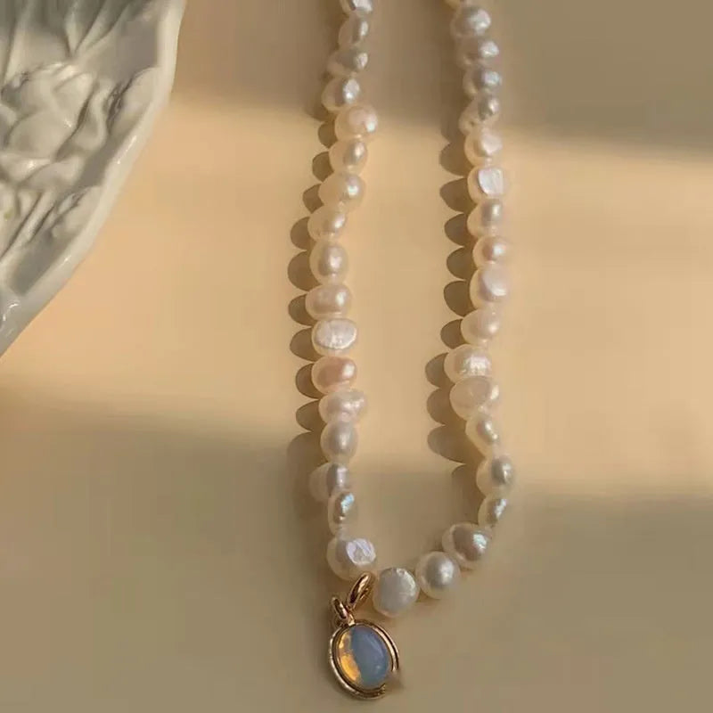 Geometric French Court vintage pearl necklace with adjustable chain on a dark background.