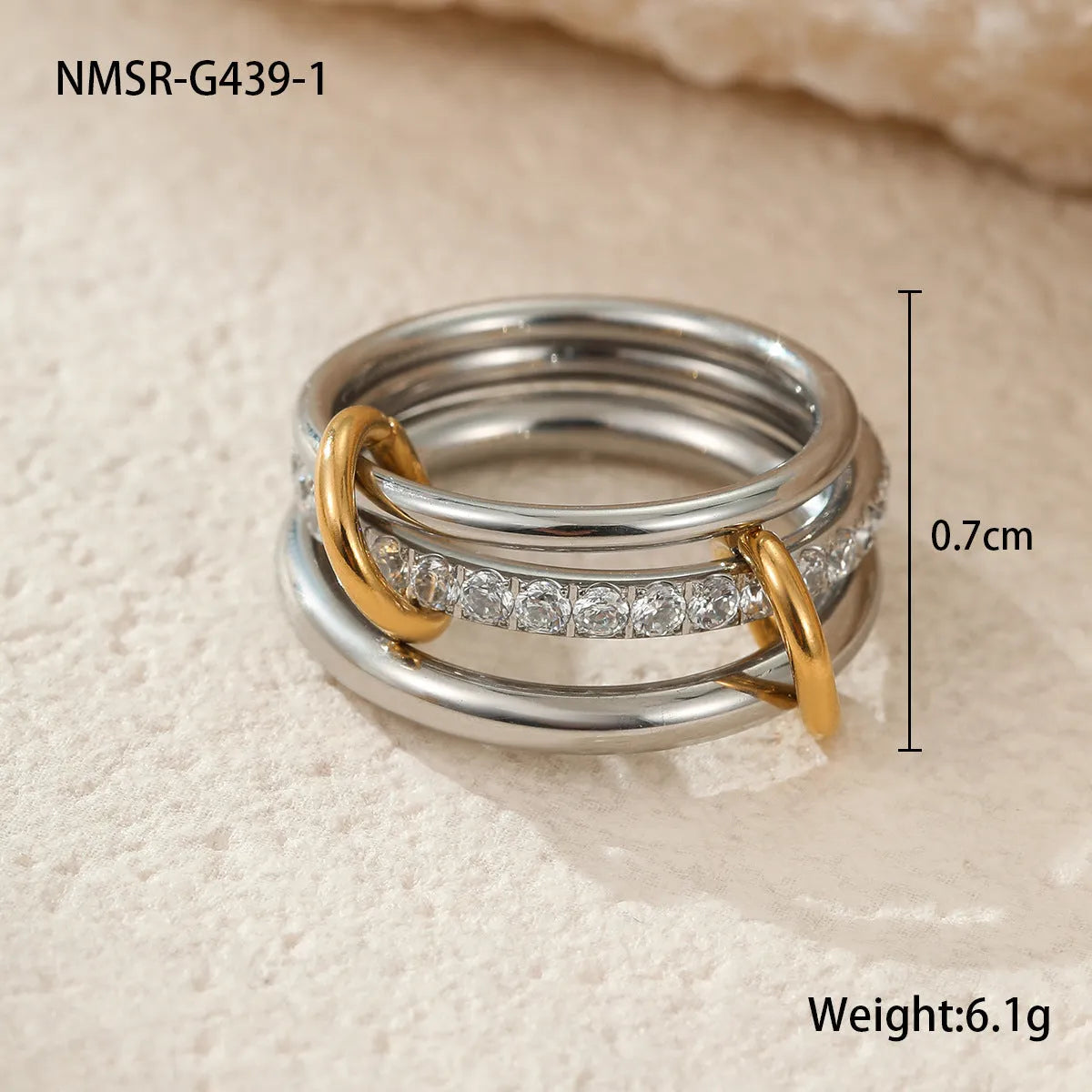 Gold plated exaggerated stackable ring for women on a hand, showing layered jewellery style.
