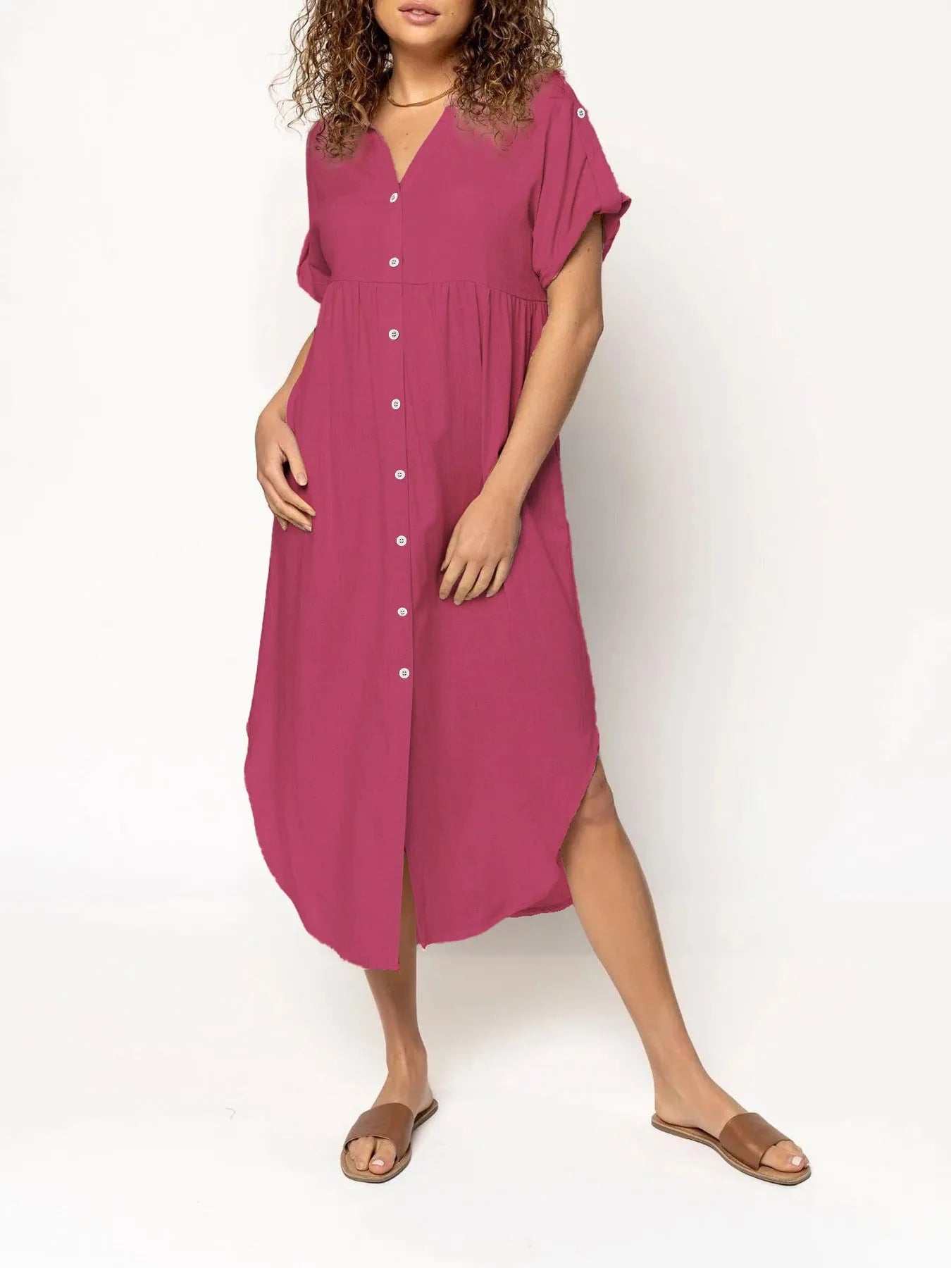A loose-fitting, mid-length casual dress with button detail on the front, shown in a solid colour.