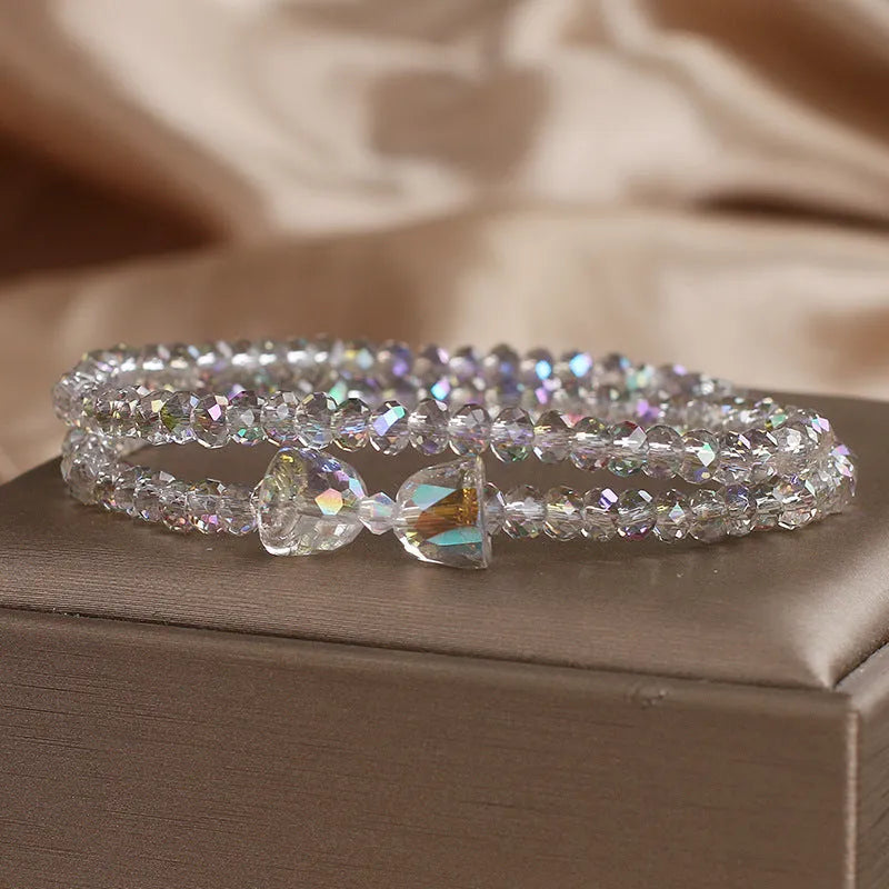 Women's double-circle crystal bow bracelet in white, green, and pink colour options on display