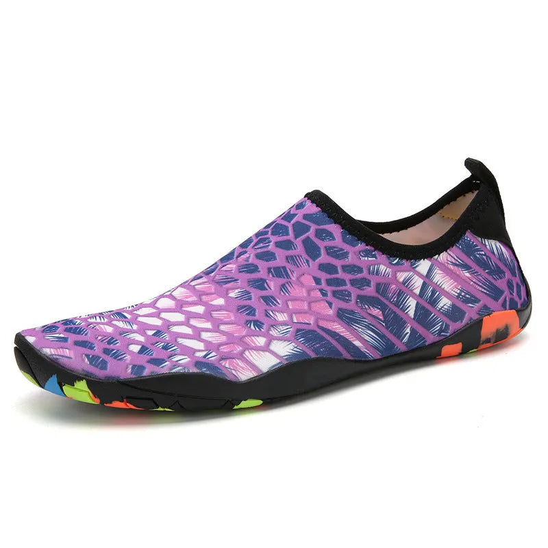 Blue Lycra beach wading shoes with EVA midsole on a sandy beach