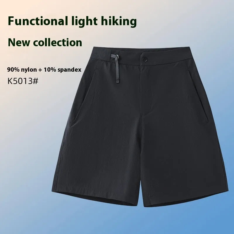 Men's solid colour quick-dry sports shorts with elastic waistband on a grey background.