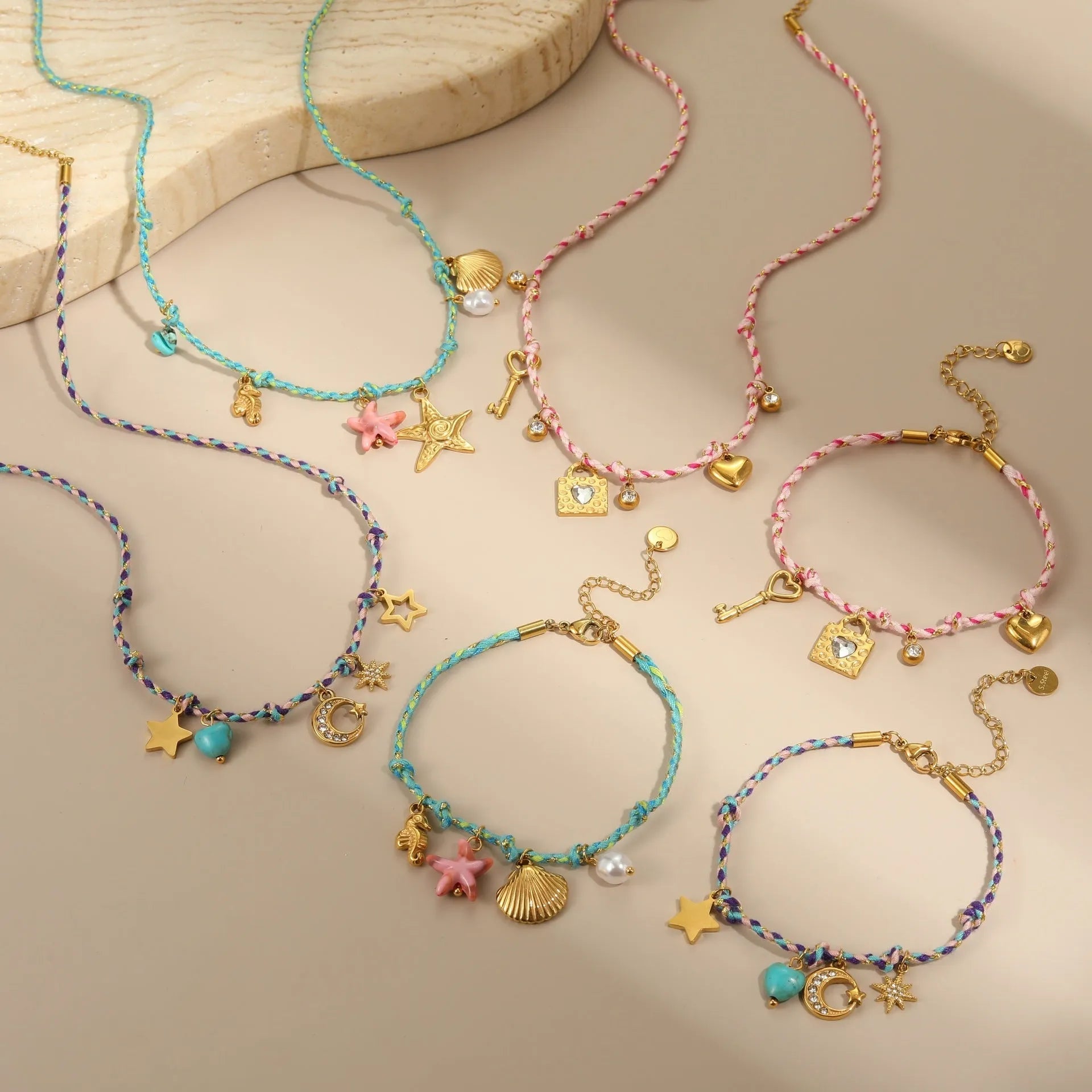 Handmade braided rope titanium steel necklace and bracelet set with 18K gold electroplated heart, star, and geometric pendants.