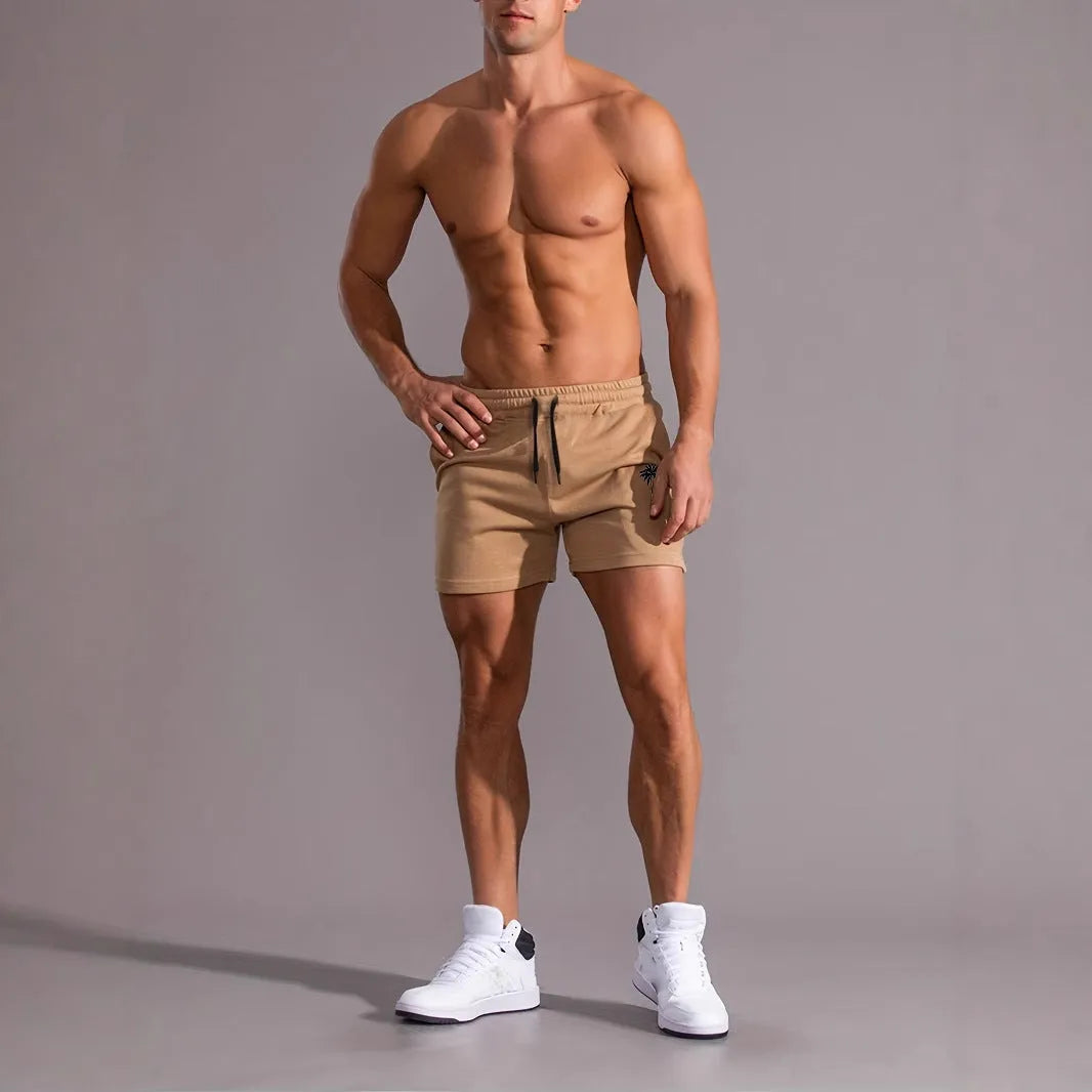 Khaki coloured men's sports shorts with coconut print design and straight cut for summer activities