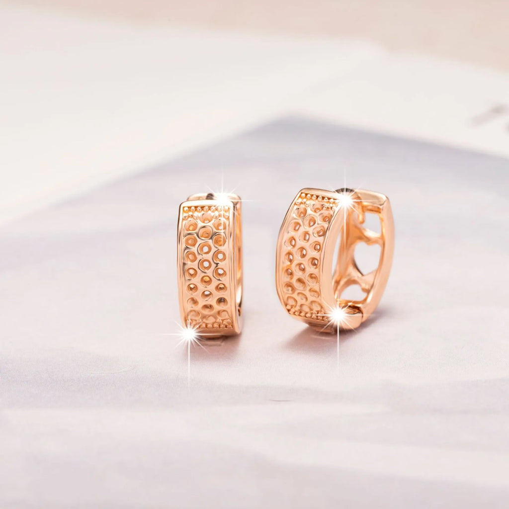Rose gold hollow heart earrings with circular design and electroplated finish
