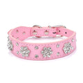 PU leather dog collar with rhinestone flower studs in black, showing metal D-ring and adjustable eyelets.