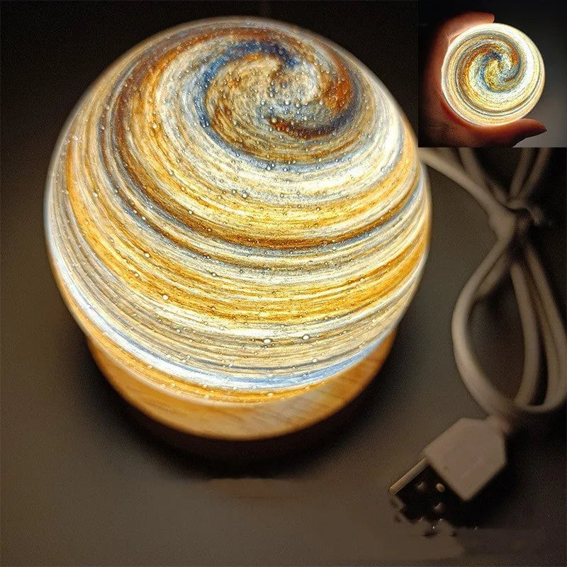Planet night light with spherical design on base, USB cable connected, showing adjustable three-colour lighting
