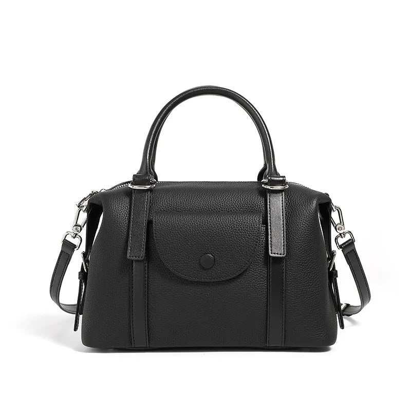 Black genuine leather ladies handbag with single shoulder strap, showing contrast lock and stitching.