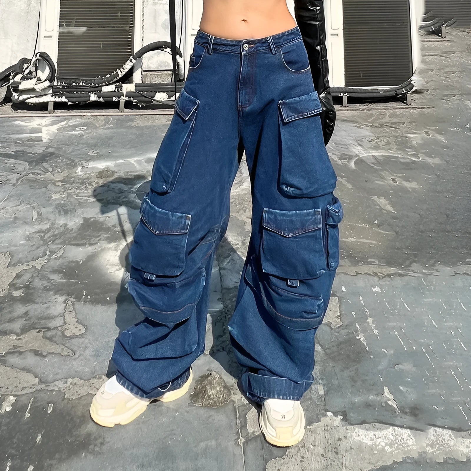 Dark blue distressed wide-leg high-waist jeans with multiple pockets on a denim background.