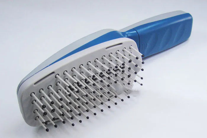 Pet comb with negative ion technology, removable brush head, and 9V battery compartment.