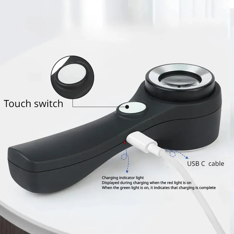 A black or silver appraisal magnifying glass with an optical glass lens and a USB-C charging cable.